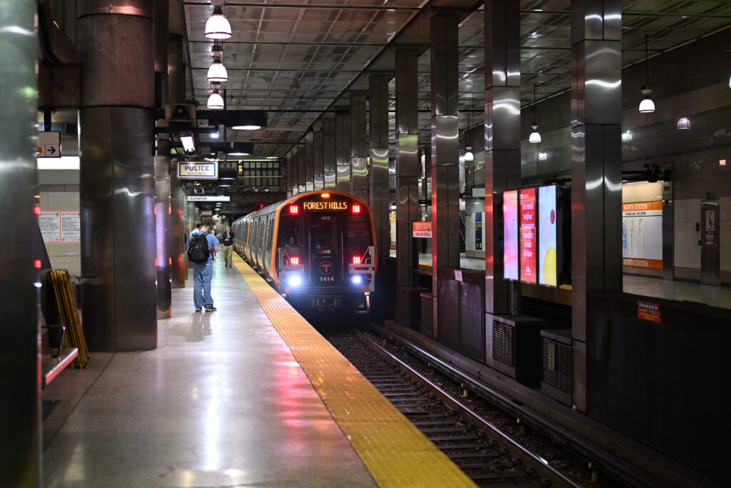 An Orange Line train at a station platform.