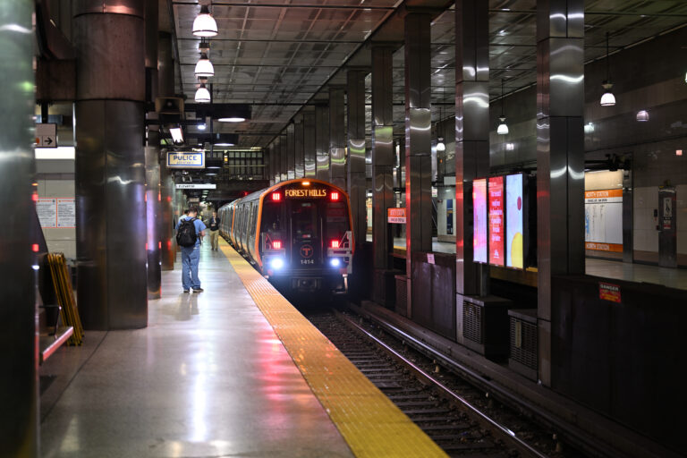 An Orange Line train at a station platform.